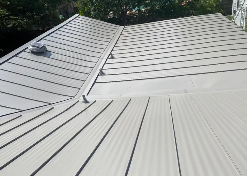 Solar attic fan installed on a metal roof for Roof Ventilation in Sunny Isles Beach